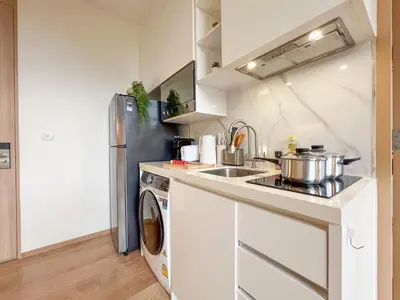 a kitchen with a sink and a refrigerator at Asoke Luxury High Rise - Steps to BTS and MRT - WiFi in Bangkok