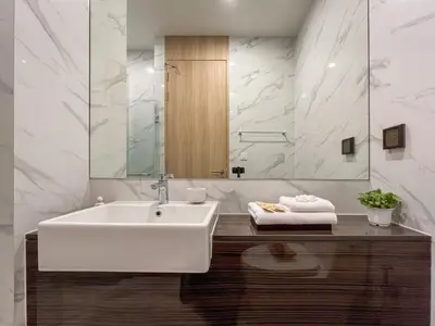 a bathroom with a white sink and a mirror at Asoke Luxury High Rise - Steps to BTS and MRT - WiFi in Bangkok