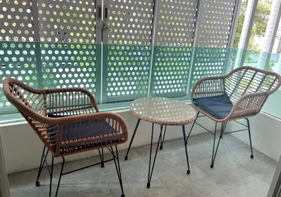 two chairs and a table in front of a window at Thong Lo 3BR Home 75in SmartTV Netflix - Quiet Home in the City Center in Bangkok