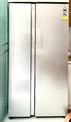 a white refrigerator with its door open in a kitchen at Thong Lo 3BR Home 75in SmartTV Netflix - Quiet Home in the City Center in Bangkok