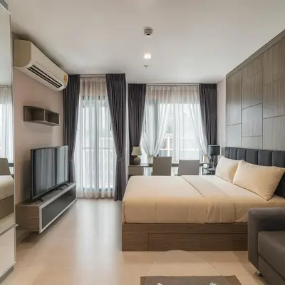 a bedroom with a large bed and a television at Stylish Sukhumvit 36 Condo Near BTS Thonglor in Bangkok