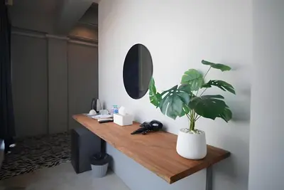 a mirror and a plant on a wooden shelf at XX The Character Yaowarat-ตรอกข้าวสาร in Samphanthawong