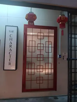 a door in a room with a sign on the wall at XX The Character Yaowarat-ตรอกข้าวสาร in Samphanthawong