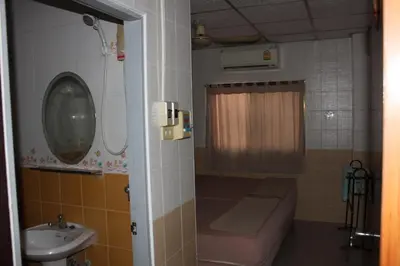 a small bathroom with a sink and a toilet at At Home Guest House in Bangkok