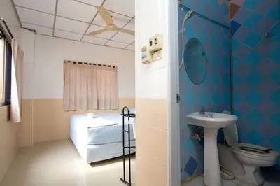 a bathroom with a toilet and a sink at At Home Guest House in Bangkok