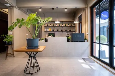 a potted plant sitting on a table in a room at Crownex Studio Deluxe in Bangkok