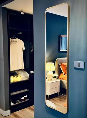 a mirror in a room with a bed and a bedroom at Omni Tower Sukhumvit Nana - Luxury Condominium in Bangkok