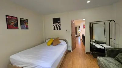 a bedroom with a bed and a living room at TownHouse near Central Ladprao with bathtub in Bangkok
