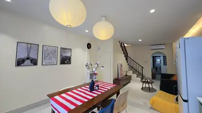 a living room with a table and a couch at TownHouse near Central Ladprao with bathtub in Bangkok