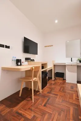 an office with a desk and a chair and a table at Tori primo hotel in Bangkok