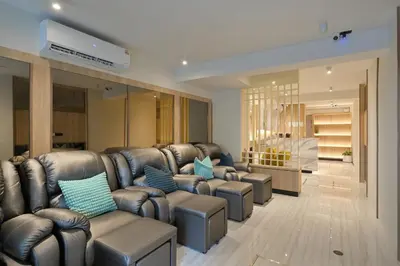 a waiting room with leather couches and blue pillows at Tori primo hotel in Bangkok