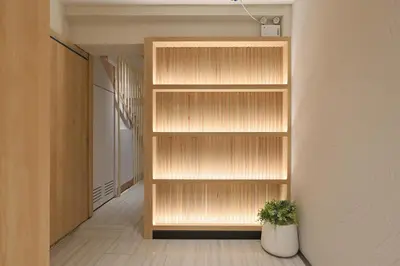 a book shelf in a hallway with a potted plant at Tori primo hotel in Bangkok
