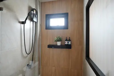 a bathroom with a shower with a window at Tori primo hotel in Bangkok