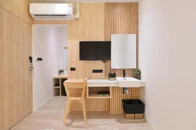 a room with a desk with a tv on the wall at Tori primo hotel in Bangkok