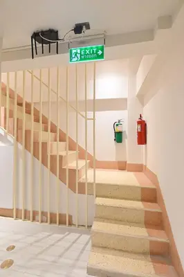 a staircase in a room with a exitexit sign at Tori primo hotel in Bangkok