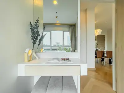 a white kitchen with a sink and a mirror at Elegant Stay near IconSiam l High-speed WiFi l BTS Wongwian Yai in Bangkok