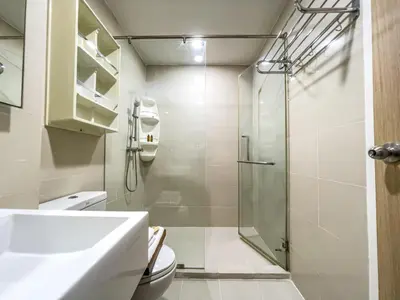 a bathroom with a glass shower and a toilet at Elegant Stay near IconSiam l High-speed WiFi l BTS Wongwian Yai in Bangkok