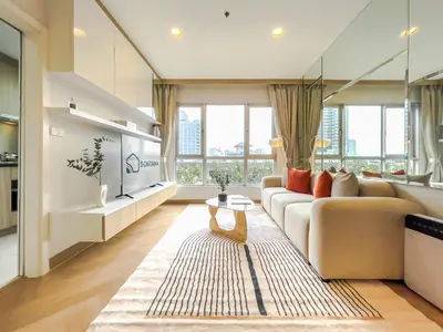 a living room with a couch and a table at Elegant Stay near IconSiam l High-speed WiFi l BTS Wongwian Yai in Bangkok