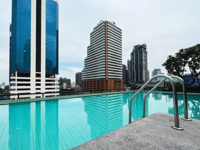a swimming pool in a city with tall buildings at Vibe Sukhumvit 61 l Ultra WIFI l Walk to BTS Thonglor or Ekkamai in Bangkok