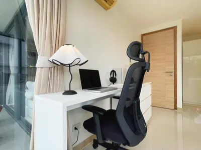 an office with a desk with a laptop and a chair at Vibe Sukhumvit 61 l Ultra WIFI l Walk to BTS Thonglor or Ekkamai in Bangkok