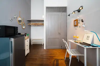 a kitchen with a desk and a laptop on a table at Large BTS 10 min 2King+Twin FastWiFi SelfCheckin in Bang Rak