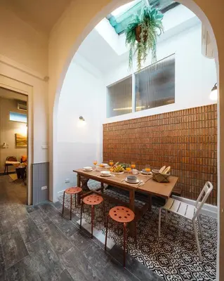 a dining room with a wooden table and chairs at Large BTS 10 min 2King+Twin FastWiFi SelfCheckin in Bang Rak
