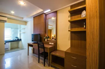 a home office with a desk and a television at The Platinum Suites Bangkok by Dancenter in Bangkok