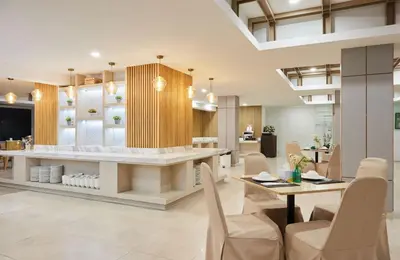 a dining room with a table and chairs at The Platinum Suites Bangkok by Dancenter in Bangkok