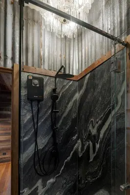 a bathroom with a shower with a hose at Vanich House - Mechanic's Room in Bangkok
