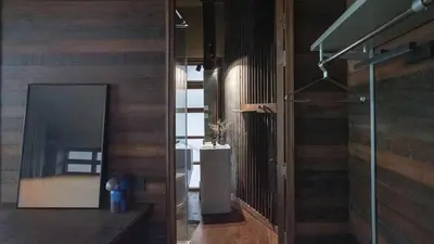 a room with a hallway with wooden walls at Vanich House - Mechanic's Room in Bangkok