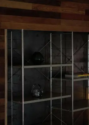 a shelf in a room with wooden walls and wooden ceilings at Vanich House - Mechanic's Room in Bangkok