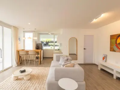 a living room with a couch and a table at 2 Bedrooms for 4 Guests with Terrace in the Heart of Sathorn in Bangkok