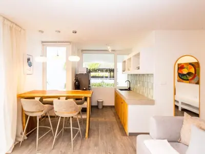 a kitchen and living room with a table and chairs at 2 Bedrooms for 4 Guests with Terrace in the Heart of Sathorn in Bangkok