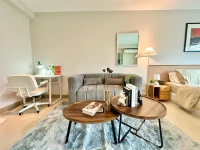 a living room with a couch and a table at Cozy City Retreat in Ekkamai in Bangkok