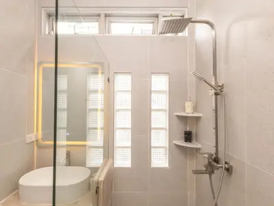 a bathroom with a shower and a toilet and a sink at 2 Bedrooms for 4 Guests with Kitchen at Heart of Sathorn in Bangkok