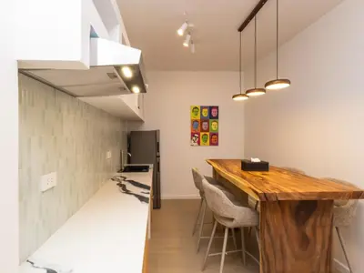 a kitchen and dining room with a wooden table at 2 Bedrooms for 4 Guests with Kitchen at Heart of Sathorn in Bangkok