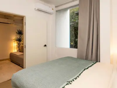 a bedroom with a bed and a window at 2 Bedrooms for 4 Guests with Kitchen at Heart of Sathorn in Bangkok