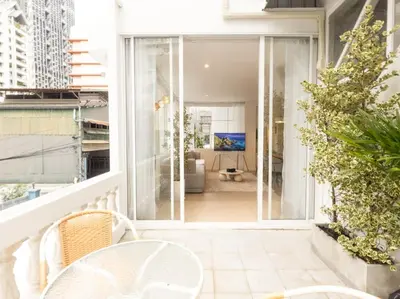 a balcony with a view of a living room at 3 Bedroom for 6 Guests Family in the Heart of Sathorn in Bangkok