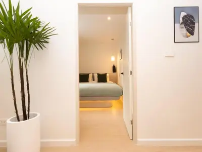 a hallway with a potted plant and a bedroom at 3 Bedroom for 6 Guests Family in the Heart of Sathorn in Bangkok