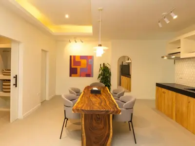 a living room with a wooden table and chairs at 3 Bedrooms for 5 Guests in the Heart of Sathorn in Bangkok