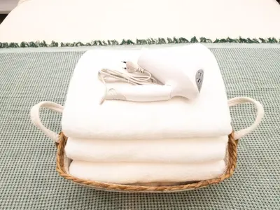 a basket of towels with a picture of a woman at 3 Bedrooms for 5 Guests in the Heart of Sathorn in Bangkok
