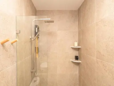 a shower with a glass door in a bathroom at 3 Bedrooms for 5 Guests in the Heart of Sathorn in Bangkok