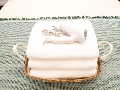 a basket of towels with a picture of a woman on them at Lovely Studio Room for 2 Guests in the Heart of Sathorn in Bangkok