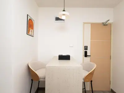 a room with a white table and two chairs at Lovely Studio Room for 2 Guests in the Heart of Sathorn in Bangkok