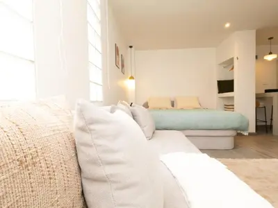 a living room with a couch and a bed at Lovely Studio Room for 2 Guests in the Heart of Sathorn in Bangkok