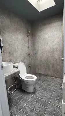 a bathroom with a toilet and a sink at Aura Hostel in Bangkok