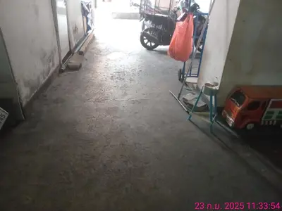 a hallway with a motorcycle parked in a room at วีวันไพร์ in Khlong Toei
