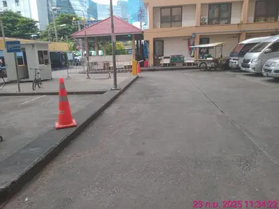 a parking lot with an orange cone in front of a building at วีวันไพร์ in Khlong Toei