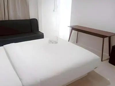 a living room with a couch and a table at x Mirt Inn Sukhumvit II - ถนนสุขุมวิท 2 in Bang Kapi
