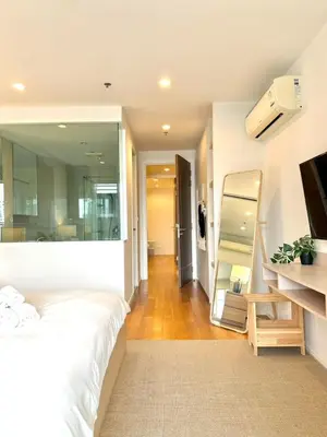 a bedroom with a large white bed and a mirror at 3BD3BA Condo|City View|Hot Tub|7-11, PoolGym, Mall in Makkasan